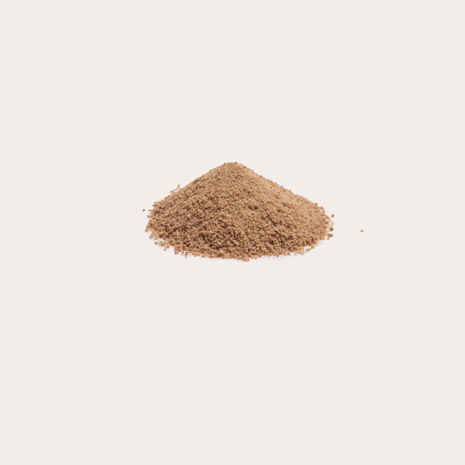 Coconut sugar in a small heap against a white background